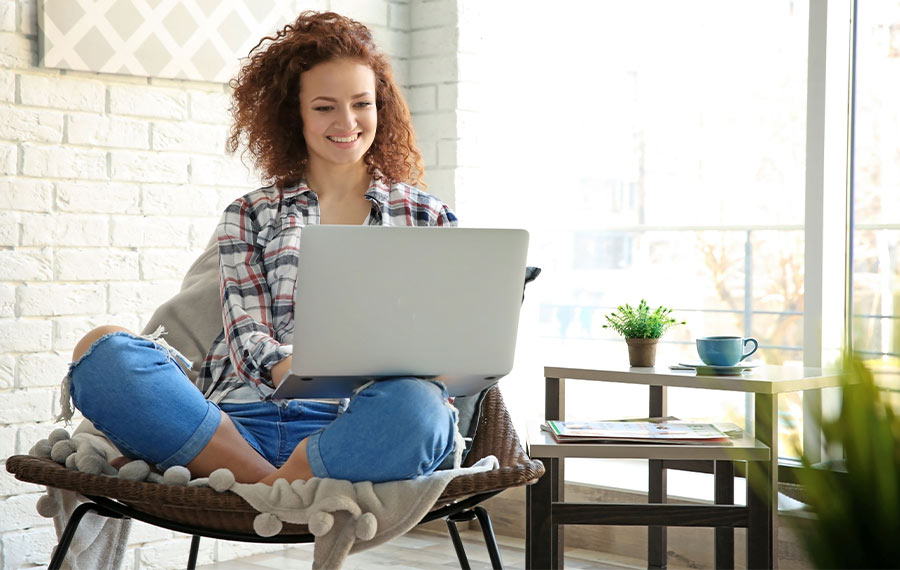 female virtual iop php client with her laptop sitting in her living room